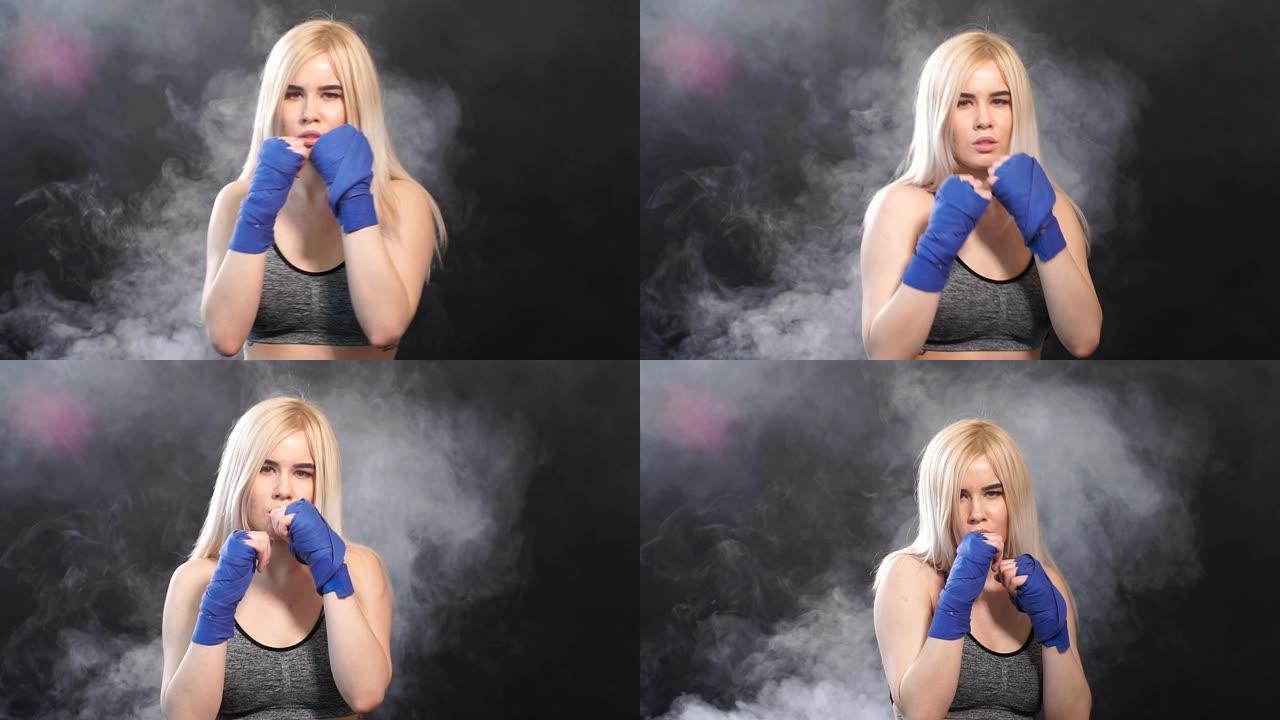 漂亮的金发女子拳击手的肖像在拳击绷带摆姿势防御拳击手的姿态