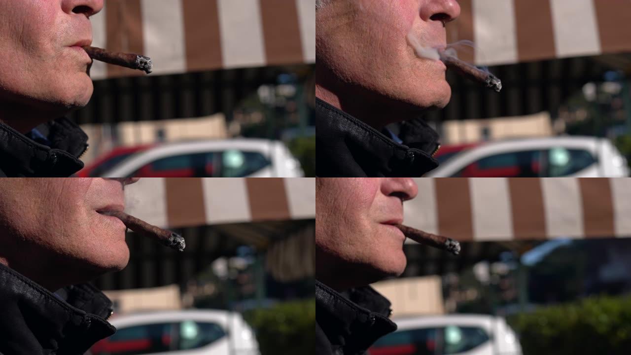 一个男人的嘴在户外抽昂贵的古巴雪茄的特写镜头。危险歹徒放松和抽豪华香烟，吸烟过程中有害的尼古丁雪茄，