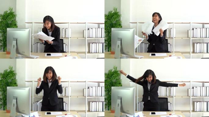 快乐的女商人正在庆祝公司活动，因为好消息大喊大叫，扔办公室文件并脱下夹克跳舞和跳跃而欢欣鼓舞。
