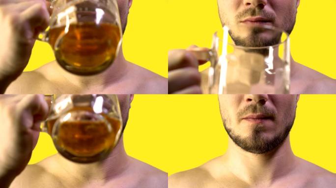 留着胡须和小胡子的男性嘴正在绿色屏幕背景上的玻璃杯中喝啤酒。啤酒节概念。