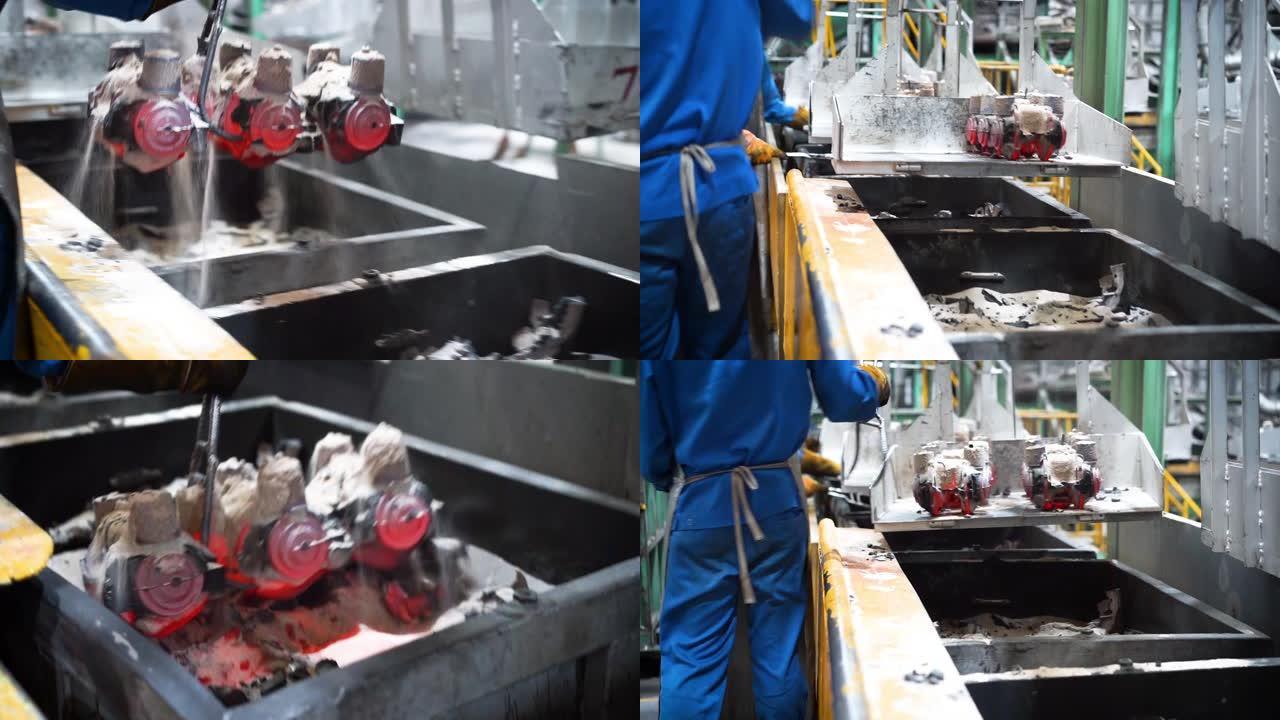 冷却线中的铸件，操作员从分动箱中取出铸件，操作员在铸造厂努力工作