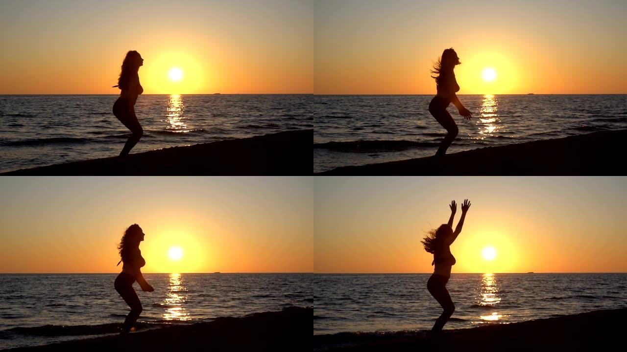 海边日落时女孩跳跃的剪影