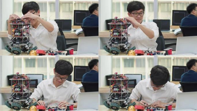 亚洲男子工程师在实验室组装和测试机器人手臂反应。建筑师设计电路使机器和机器人的技术和智能同步。