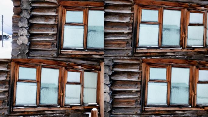 白雪皑皑的松树林中雪覆盖的木屋。冬季景观中的俄罗斯村庄。西伯利亚。4K