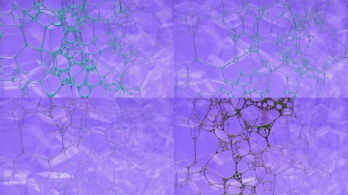彩色肥皂泡沫与爆裂气泡背景。摘要生物结构，大分子模式。蓝色墨水填充了大量在液体中形成的紫色气泡。自然