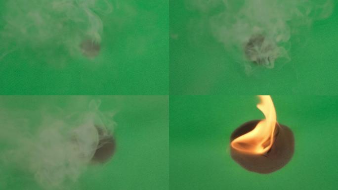 火从纸的中间烧绿纸。特写