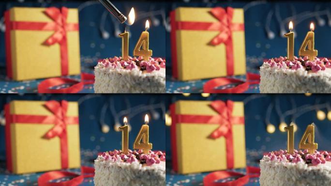 白色生日蛋糕编号14点灯燃烧的金色蜡烛，带灯的蓝色背景和用红丝带绑起来的礼物黄色盒子。特写