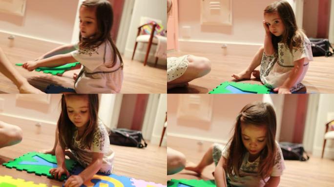 小女孩在家里玩大拼图，完成慢跑学习字母