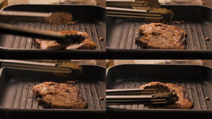 特写镜头在热锅中烹饪和烧烤猪排，选择聚焦浅景深