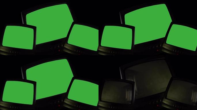 黑色背景上的三台老式电视，在绿色屏幕上切换的电视，用于图片，视频或书写的色度键屏幕。电视屏幕变色、噪