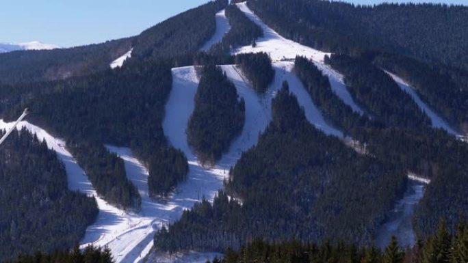 晴天滑雪胜地的雪坡。滑雪者去山上