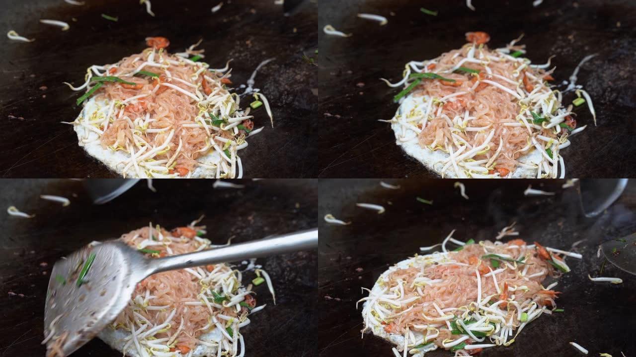 厨师正在为喜欢泰国菜的顾客烹饪的平底锅上的泰国菜特写菜单。