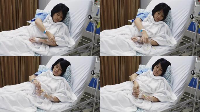 亚洲妇女咳嗽和病人床上戴着口罩。