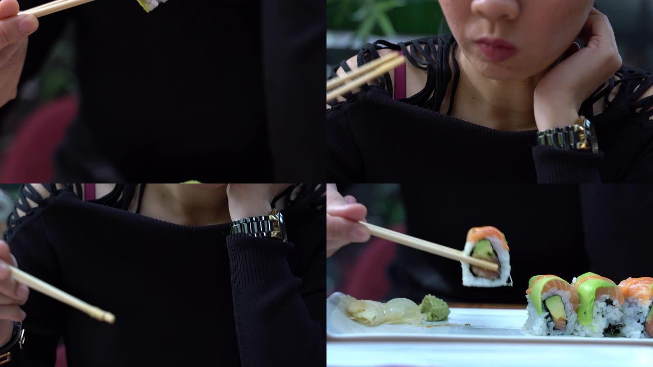 吃寿司武士卷鲑鱼生鱼片蘸酱油。