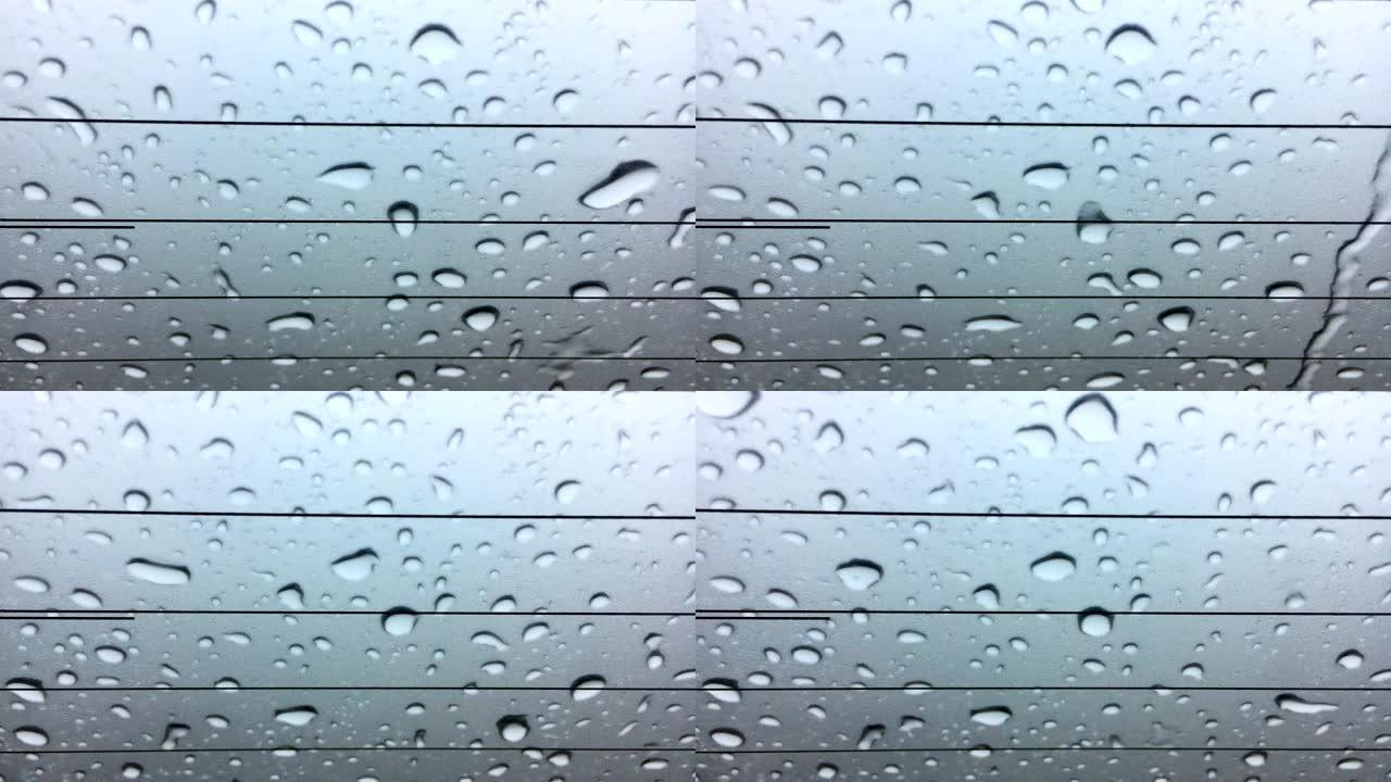 雨水落在窗户上车窗玻璃水滴滑落意境美