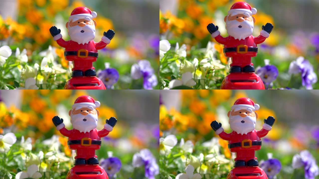 圣诞老人雕像在4k慢动作60fps的花朵背景上摇晃