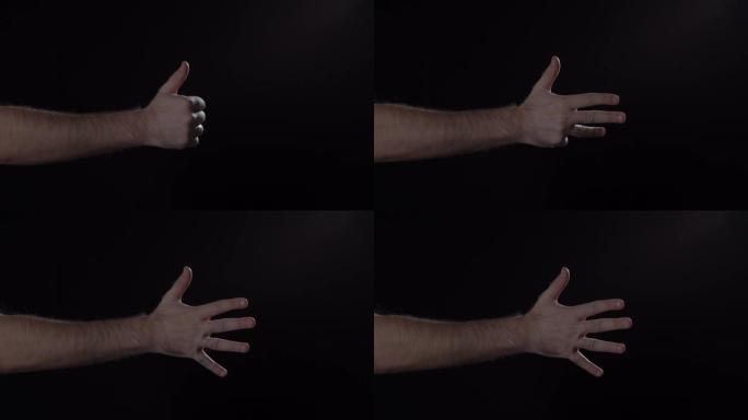 男人的手显示用手指从1到5在黑色背景上计数。4K，孤立，黑色