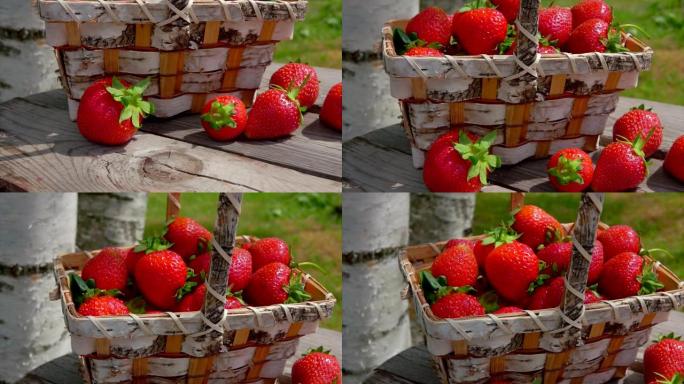户外木桌上篮子里成熟的红草莓全景