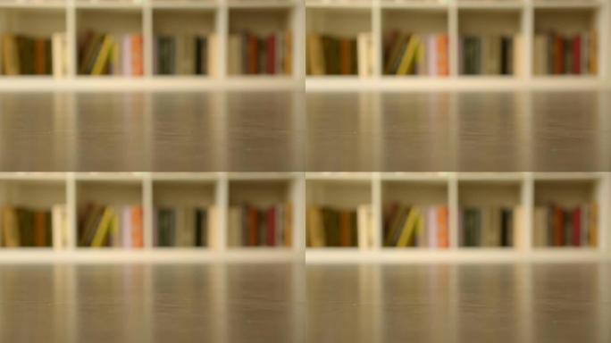 在图书馆用书拍摄书架，室内现代室内背景模糊