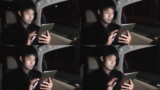 夜间年轻人在汽车旅行时使用笔记本电脑