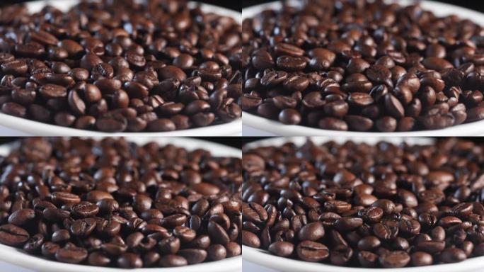 芬芳的咖啡豆在慢动作的白色盘子中旋转