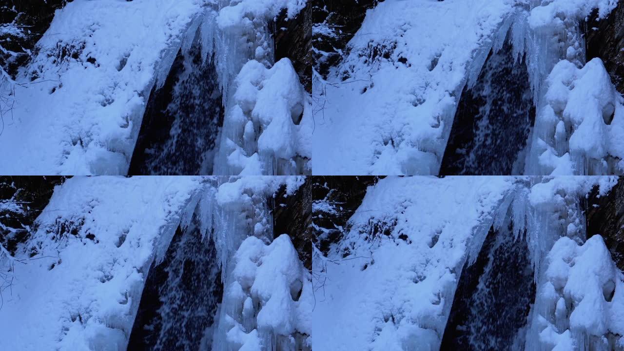 森林中喀尔巴阡山脉的冰冻冬季瀑布古克