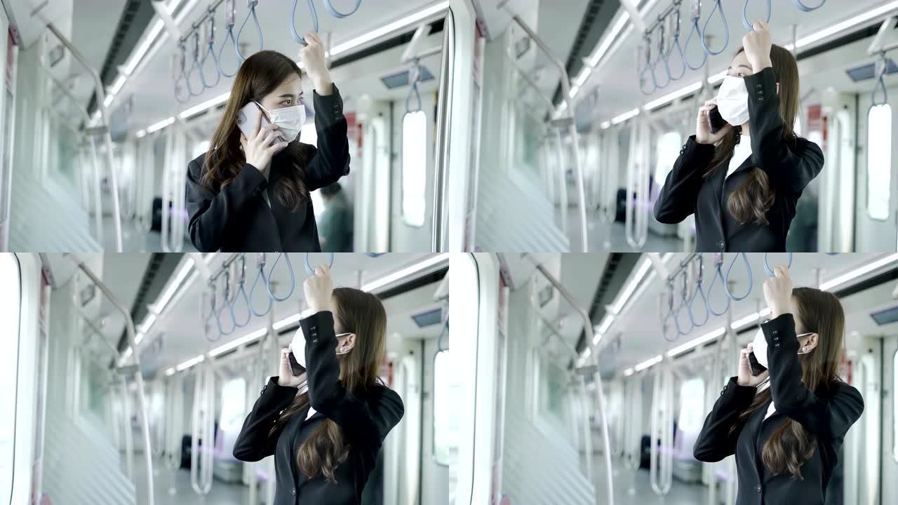 年轻的亚洲妇女戴着白色外科口罩，在地铁列车上使用手机在新型冠状病毒新型冠状病毒肺炎