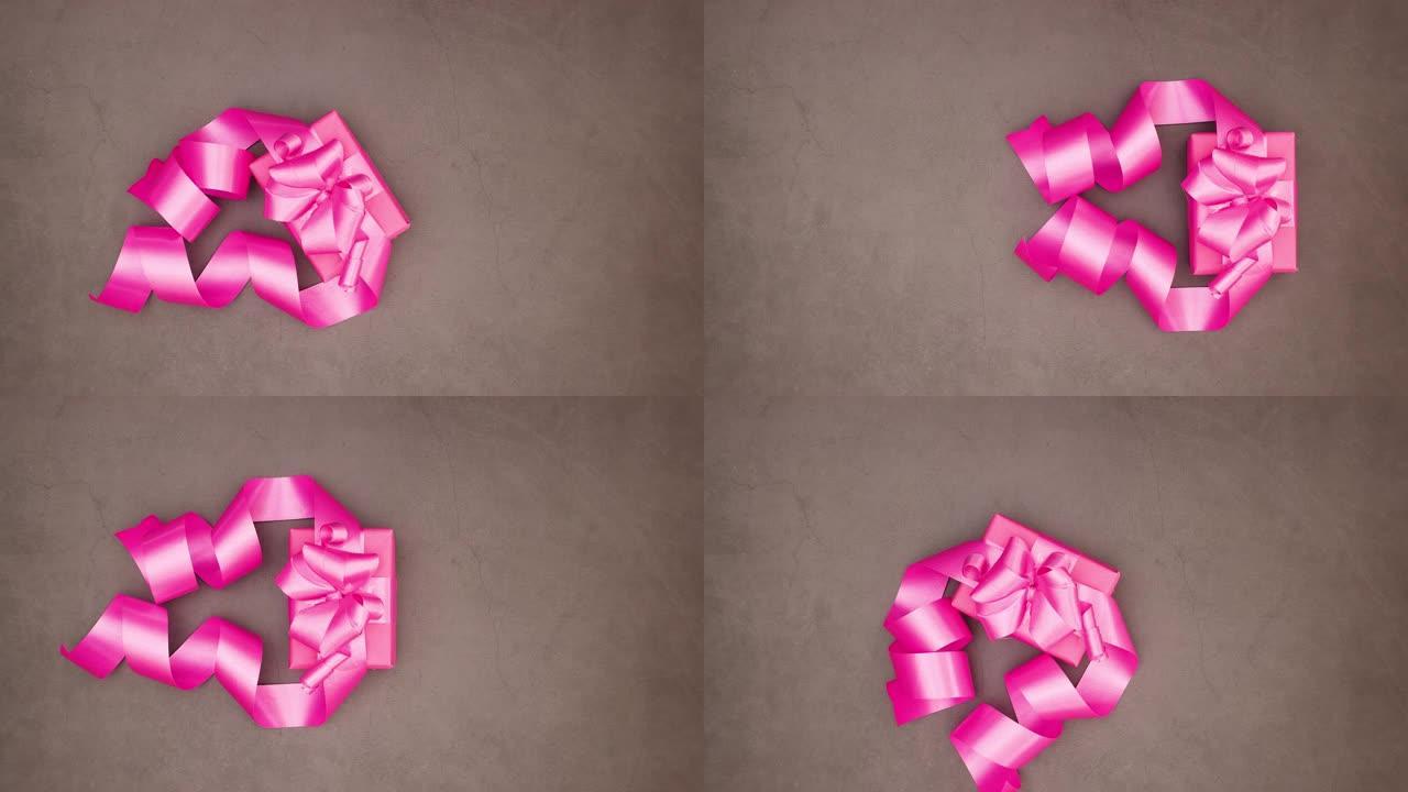 粉色大粉色丝带礼物在灰色背景下运行-情人节停止运动