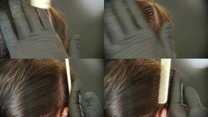理发师分段刷客户的湿头发