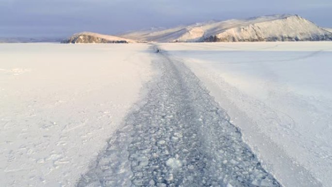 冰冻贝加尔湖表面的破冰船。蓝天白雪。美丽的冬季陆地