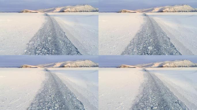 冰冻贝加尔湖表面的破冰船。蓝天白雪。美丽的冬季陆地