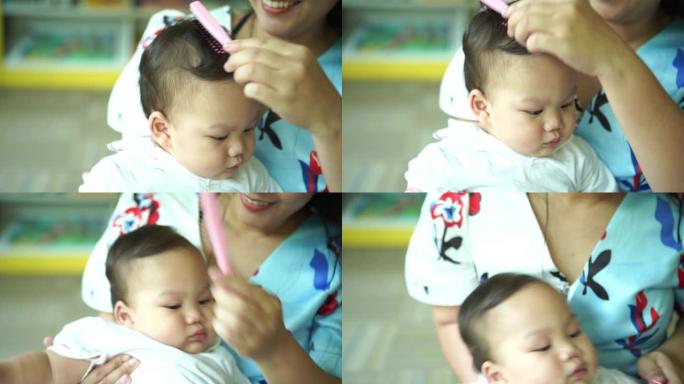 母亲为婴儿梳理健康的头发