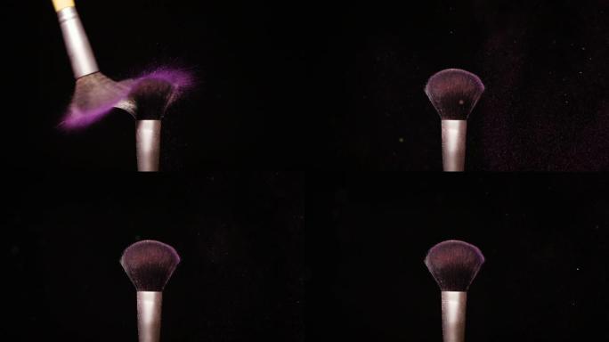 黑色背景下彩色紫色粉末化妆刷慢动作