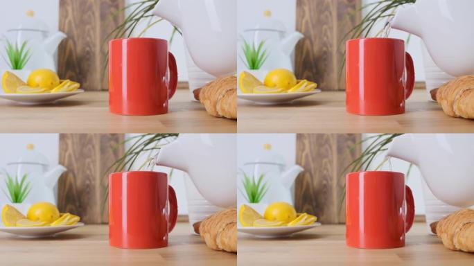 将热咖啡倒入橡木桌上的红色杯子。特写。