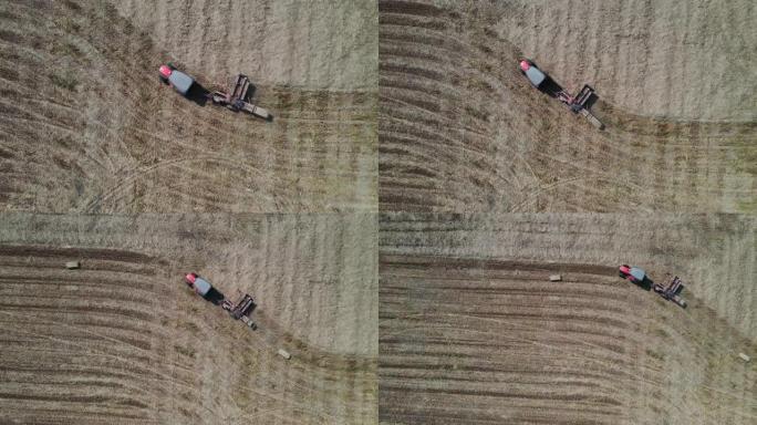 鸟瞰农场工人携带圆形圆柱形稻草堆，农田