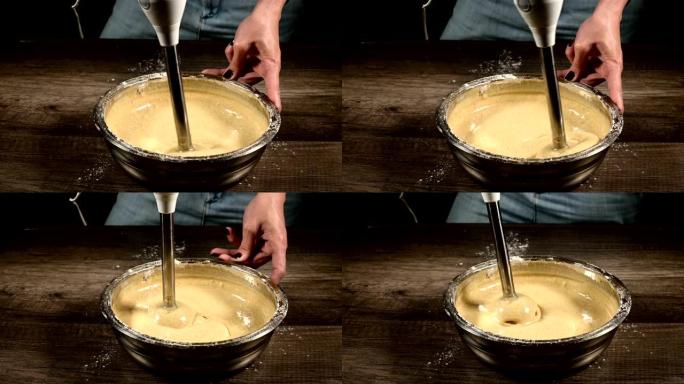 厨房里一个糕点女孩的特写镜头，放在一个金属碗里，用搅拌器敲打面团做海绵蛋糕。家庭烹饪糖果