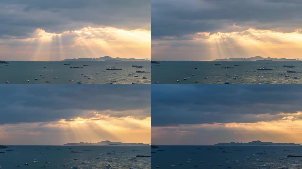 晚上日落时分令人惊叹的场景。海上的船。金光穿越云层到山海，泰国春武里府