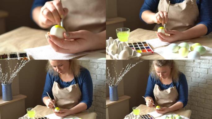 女性用水彩画鸡蛋为复活节庆祝做准备