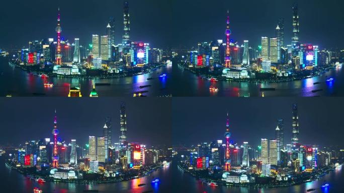 无人机在中国上海东方明珠塔附近拍摄了带有led广告屏幕的上海金融区大楼的4k鸟瞰图。晚上