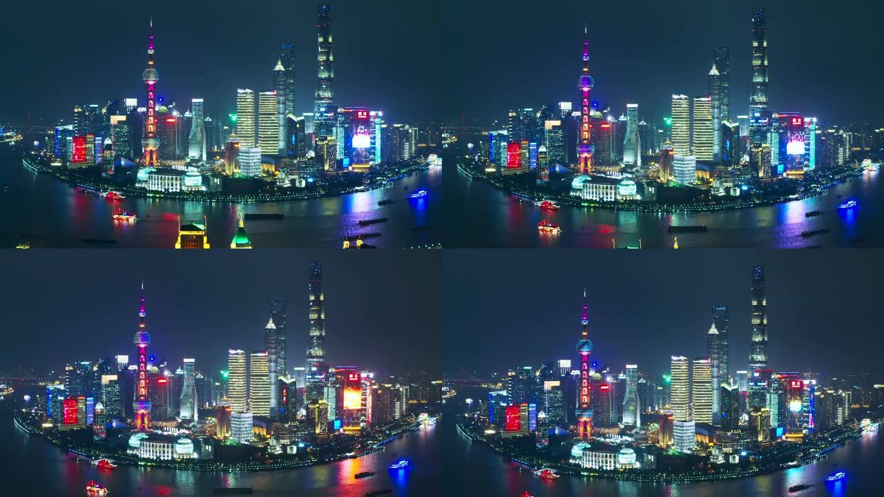 无人机在中国上海东方明珠塔附近拍摄了带有led广告屏幕的上海金融区大楼的4k鸟瞰图。晚上
