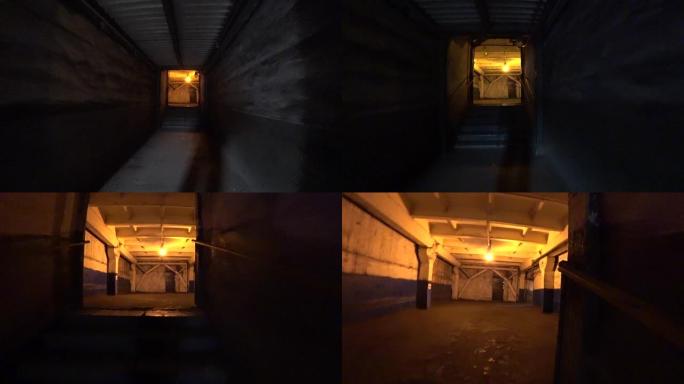 工人走过冶金厂的黑暗走廊。视点，动作相机拍摄。