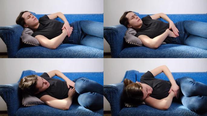 不快乐的女人躺在沙发上抱着肚子疼痛感到疼痛不适伤害腹部疼痛有胰腺炎问题，消化不良症状。胃痛概念