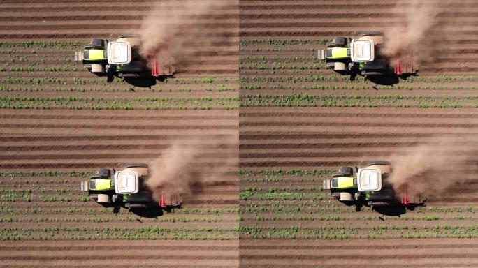 马铃薯田的农业机械在土地上耕作