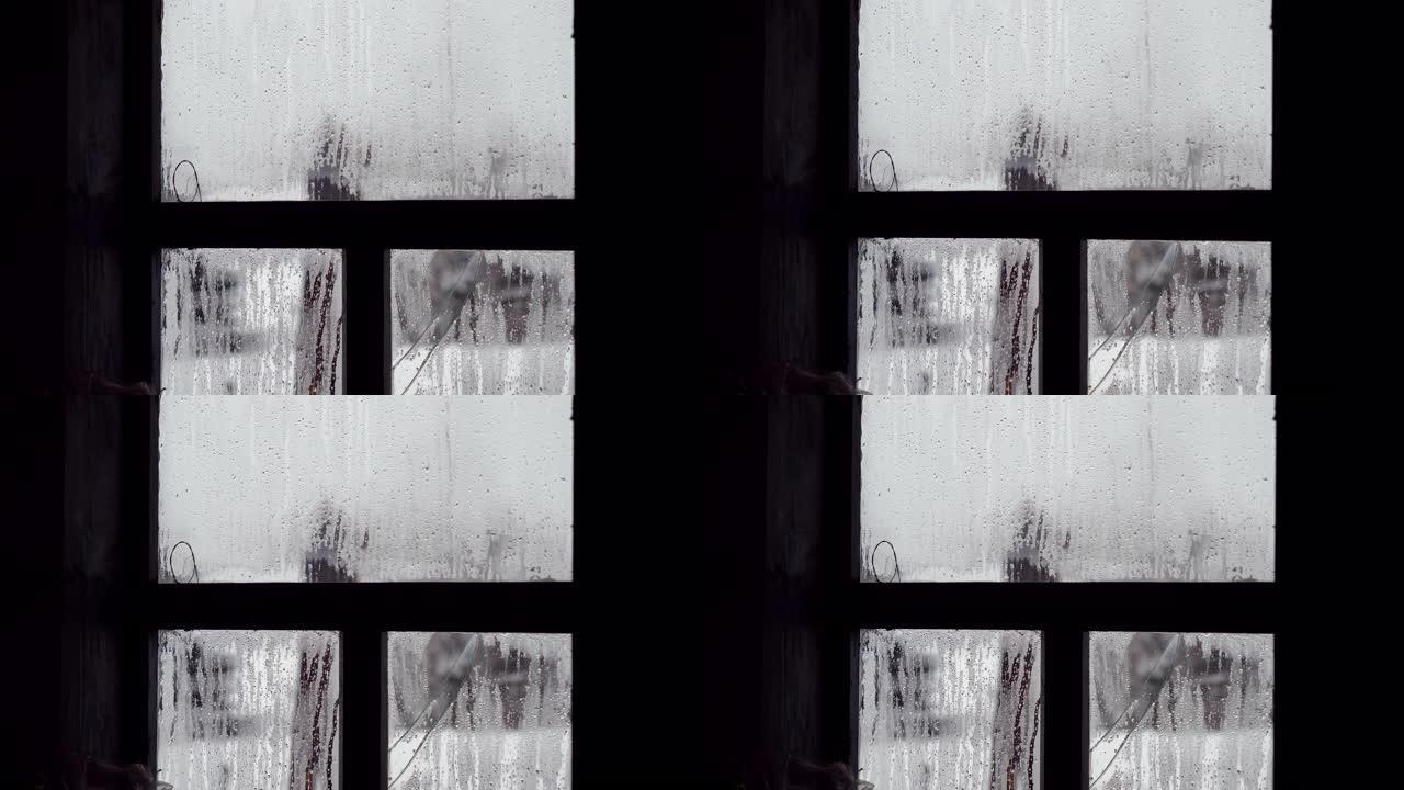 俄罗斯老房子破碎的窗户玻璃上的水滴特写镜头。4K