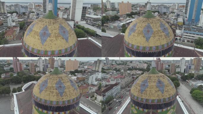 空中盘旋在巴西亚马逊河玛瑙斯歌剧院的圆顶上，用巴西国旗颜色的瓷砖装饰