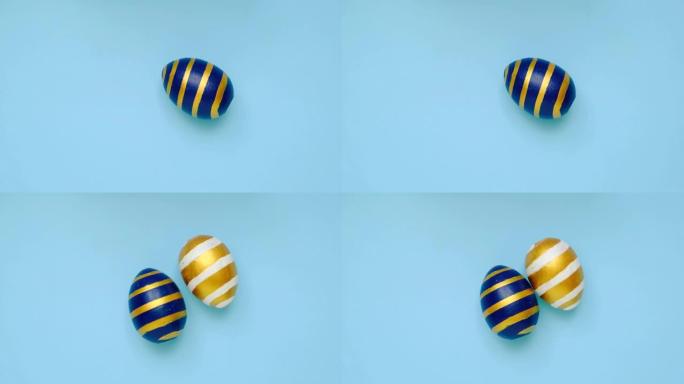复活节彩蛋在蓝色桌子上旋转。鸡蛋时尚彩色经典蓝色、白色和金色。复活节快乐。最小风格。顶视图