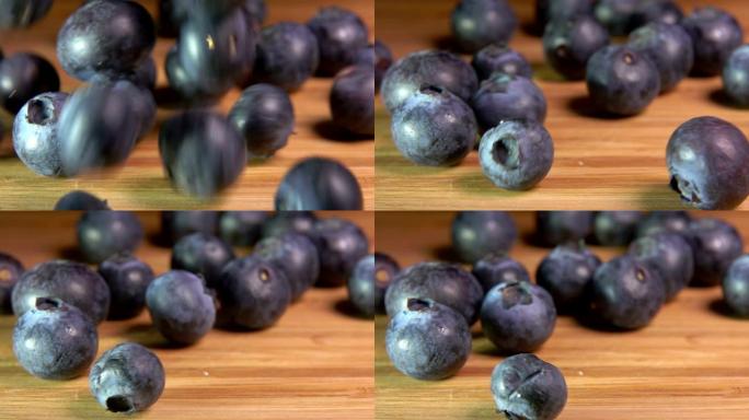 大蓝莓落在木桌上榨汁机泡水果水果入水