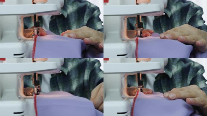 职业女裁缝在缝纫机上工作。在裁缝工作室里，女性手缝布料的特写镜头。创造和剪裁服装。手工服装的女人