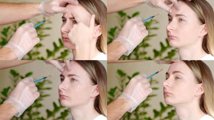 专业美容师的手在女性额头上注射肉毒杆菌毒素