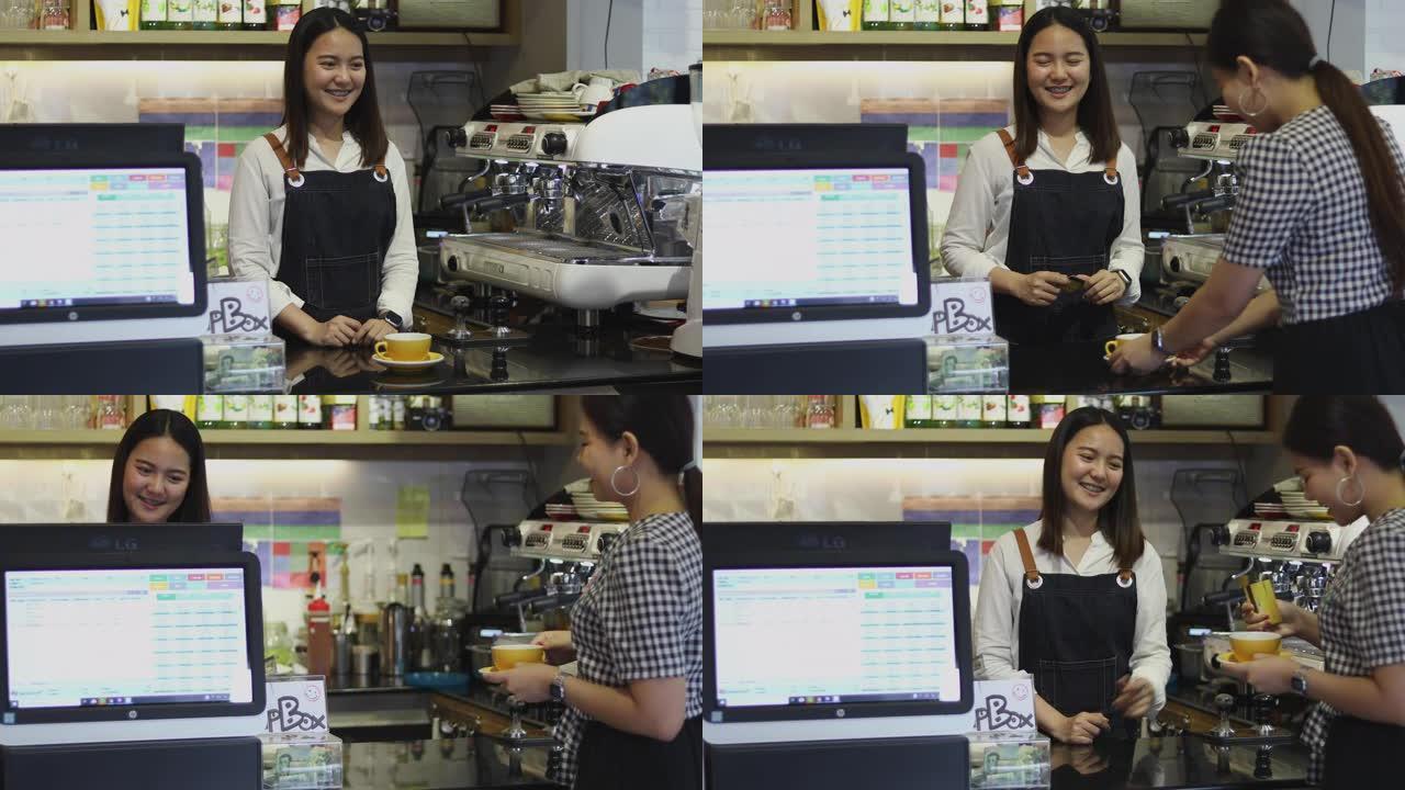 咖啡师服务顾客和女人在咖啡店用信用卡支付咖啡